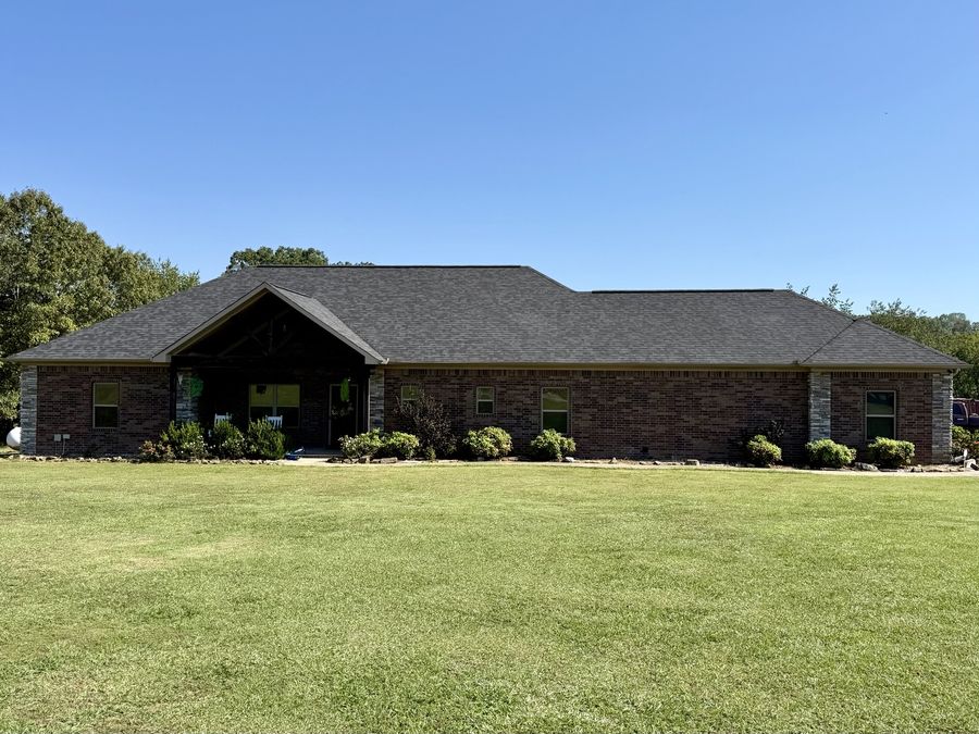 Same brick home with new shingle roof after replacement by Presley Roofing
