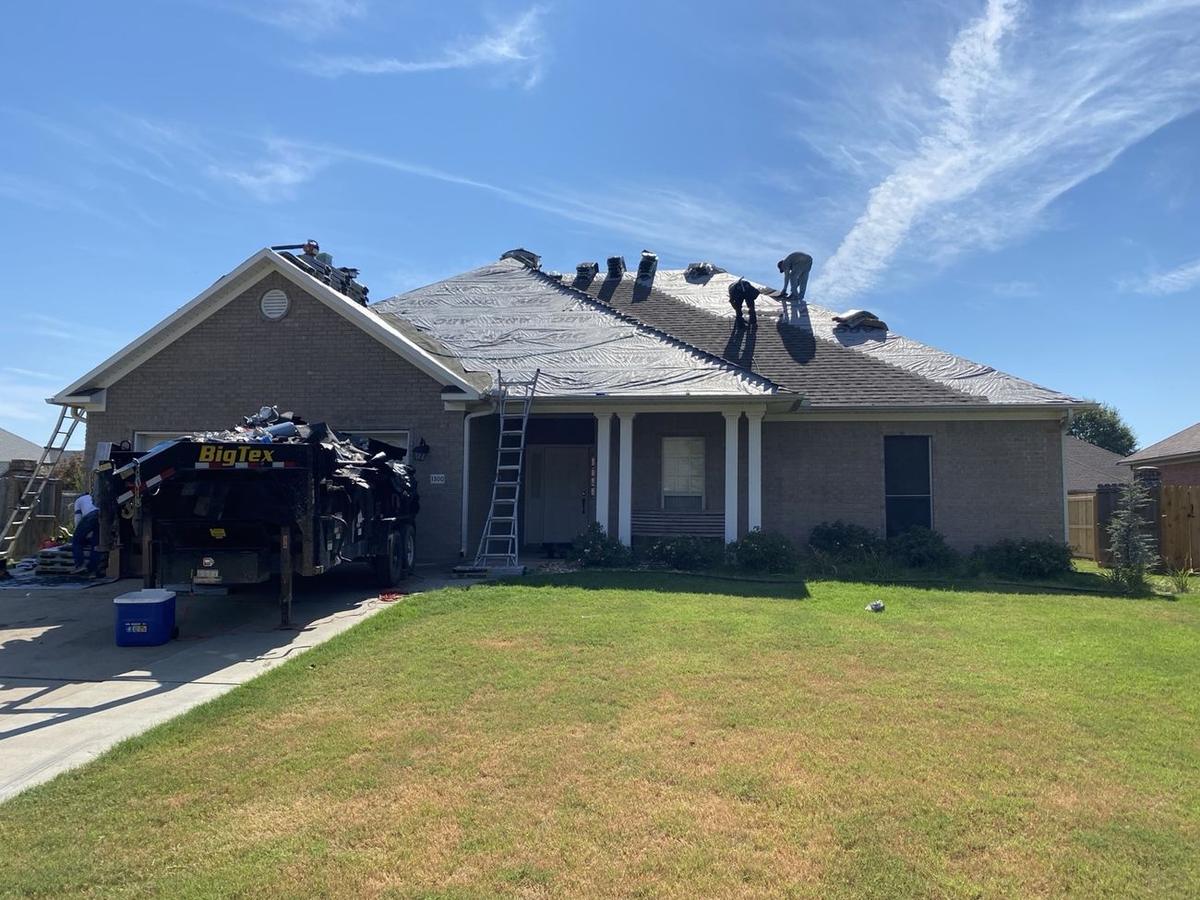 Presley Roofing crew installing a new roof on a residential home
