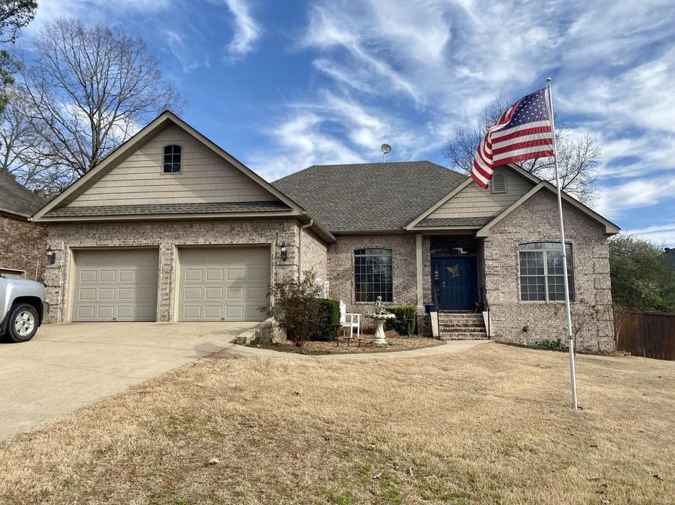 Completed residential shingle roof by Presley Roofing on a brick home