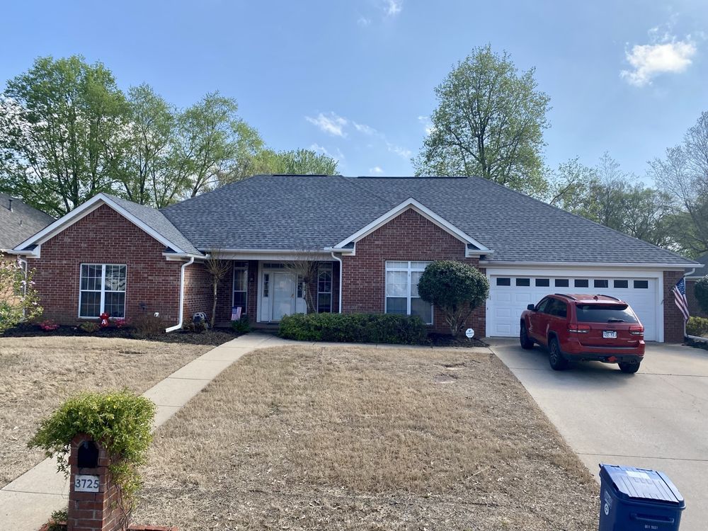Completed residential shingle roof by Presley Roofing on a red brick ranch home