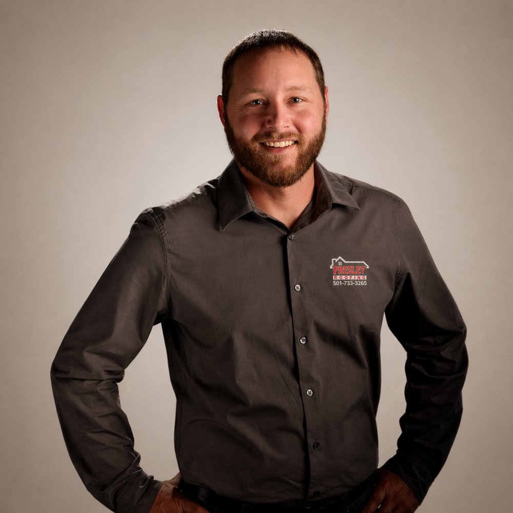 Kenny Presley, owner of Presley Roofing, wearing a Presley Roofing shirt