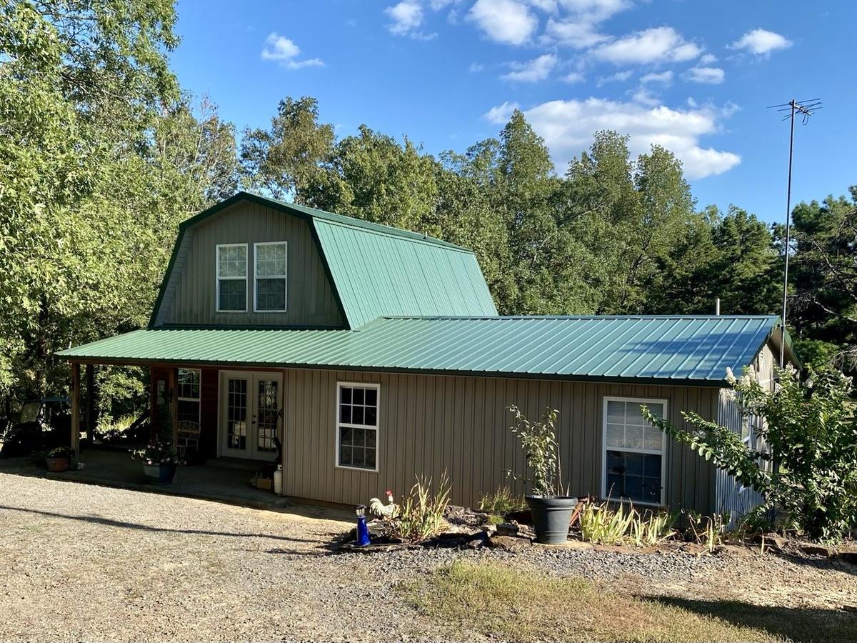 Green residential metal roof installed by Presley Roofing
