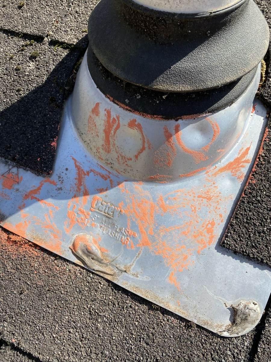 Hail damage marked on metal roof flashing during a Presley Roofing inspection